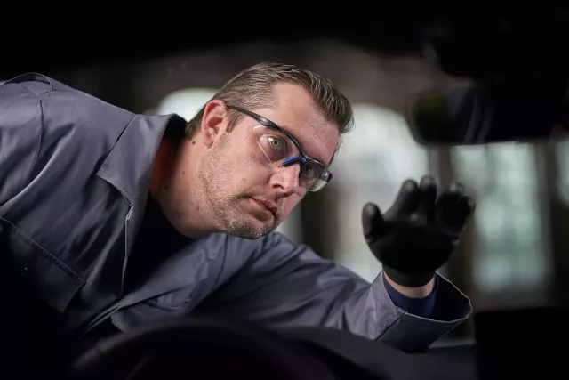 A man checking a windshield
